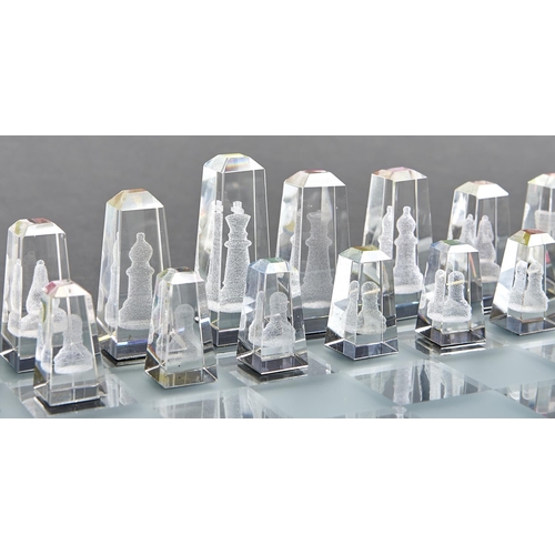 1075 - A Regency Fine Arts lead crystal chess set,  with frosted and clear glass board, the pieces frosted ... 