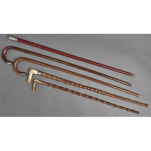 1089 - Five silver mounted and other walking canes and sticks, all c1900, three of bamboo, two with antler ... 