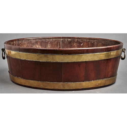 1128 - A George III brass bound oval mahogany wine cooler, late 18th c, with hinged brass handles, 19cm h, ... 