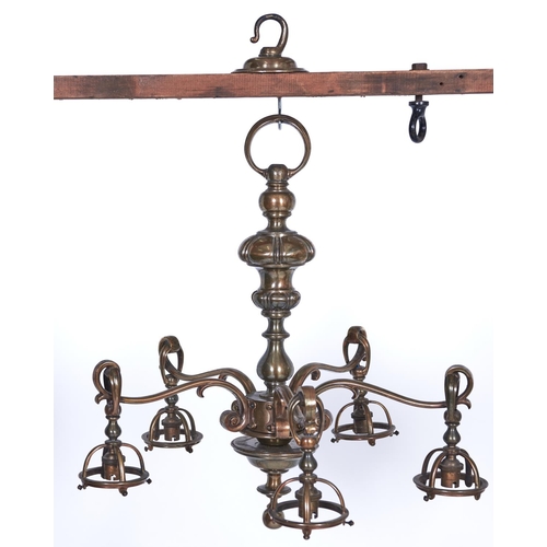 1141 - A brass chandelier, c1920, of five lights with mushroom knopped baluster shaft and swan neck branche... 