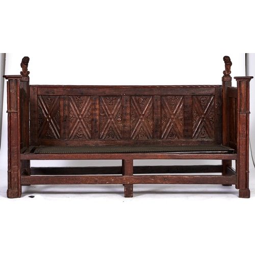 1470 - A French oak settle, 19th c, in late medieval style, with lion finials and carved panels to the back... 