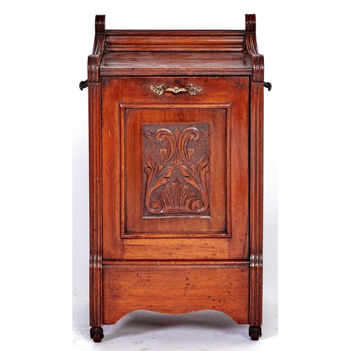 1479 - A Victorian mahogany coal box, the front hinged door inset with carved panel, on brown pottery casto... 