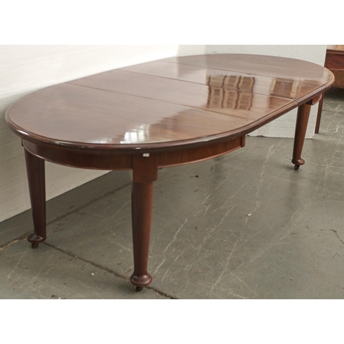 1533 - A mahogany extending dining table, c1920's, the oval ended top with moulded lip above a shallow apro... 