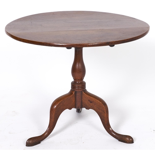 1541 - A George III oak tripod table, early 19th c, the round top on baluster pillar, 67cm h; 81cm diam... 