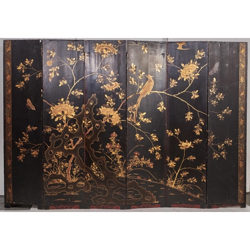 1549 - A Chinese gilt and black export lacquer six leaf screen, early 19th c, decorated with a palace compl... 