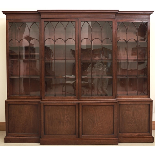 1561 - A George III mahogany breakfront library bookcase, c1800, the upper part with cavetto cornice and fi... 