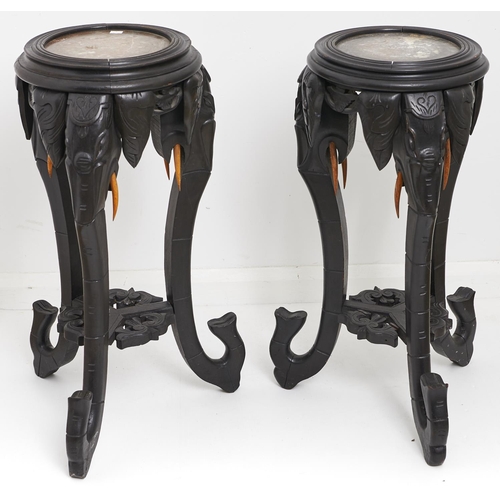 1609 - A pair of oriental marble topped ebonised jardinere stands, early 20th c, the circular tops above th... 