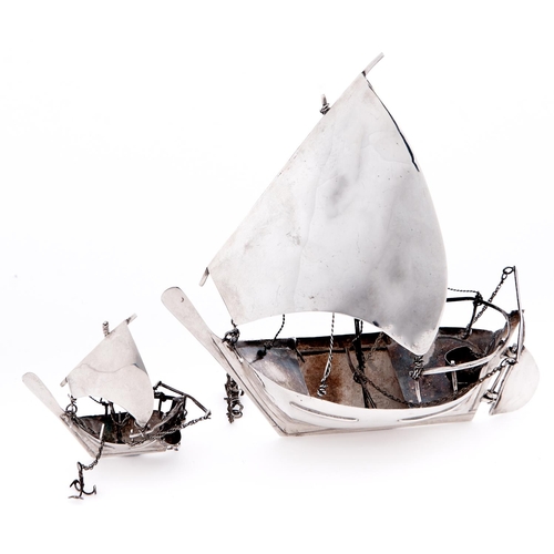 638 - A South East Asian silver model of a boat and a similar smaller model, 20th c, unmarked, 2ozs 10dwts... 