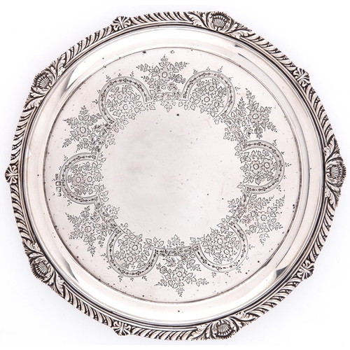 715 - A Victorian gadrooned silver salver, the field engraved with a border of flowers and strapwork, on t... 