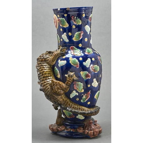 774 - A majolica dragon vase, late 19th c, the scaly olive green creature clinging to the blue vase, the f... 