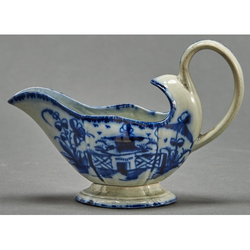 839 - A pearlware sauceboat, c1790, painted to each side with a temple and fence flanked by flower and par... 