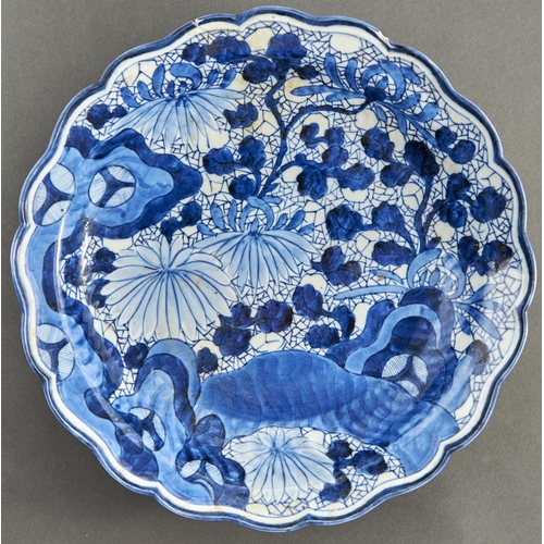 859 - A Japanese blue and white dish, Arita, 18th c, painted with flowering plants in slightly upturned, l... 