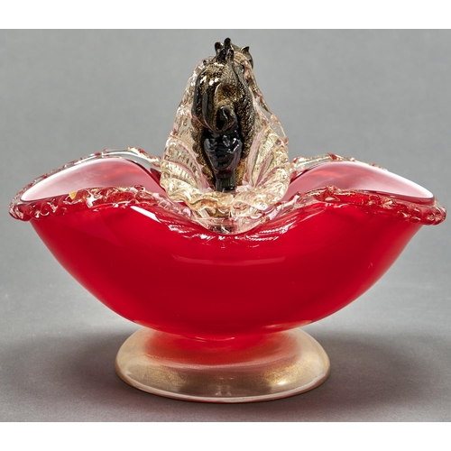 879 - A Venetian red and black glass bowl, mid 20th c, the handles on the pinched rim in the form of a hea... 