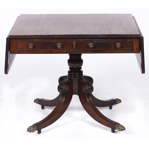 1513 - A George IV mahogany sofa table, on quadruple legs with brass paw castors, 132cm l