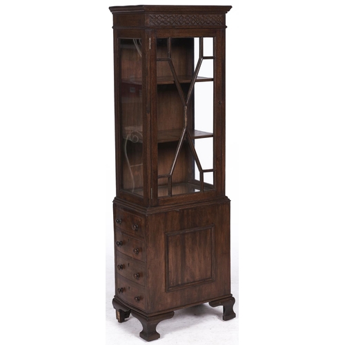1523 - An oak display cabinet, early 20th c, with blind fret carved frieze, on associated mahogany drawer p... 