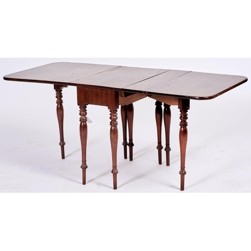 1527 - Nursery Furniture. An unusual early Victorian mahogany drop leaf dining table, c1850, on baluster le... 