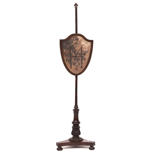 1528 - A George IV mahogany polescreen, with shield shaped banner frame, 144cm h