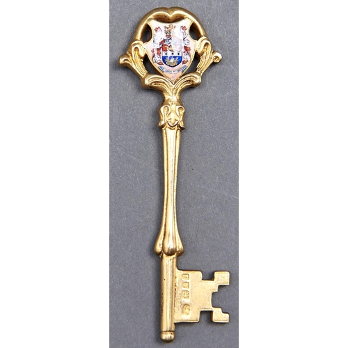 1001 - A George V silver gilt and enamel ceremonial key, engraved Blyth Fire Station Presented by Messrs T ... 