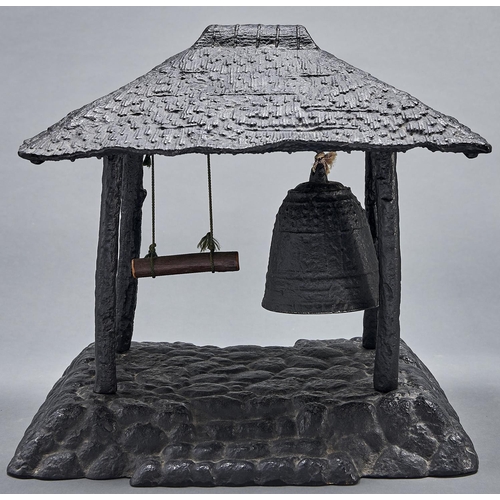 1089 - A South East Asian black painted cast metal gong, in the form of a temple bell beneath thatched roof... 
