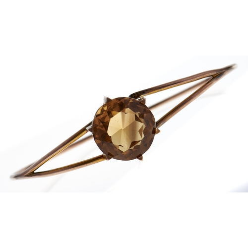 123 - A citrine bangle, c1900, in gold wirework, 10.4g