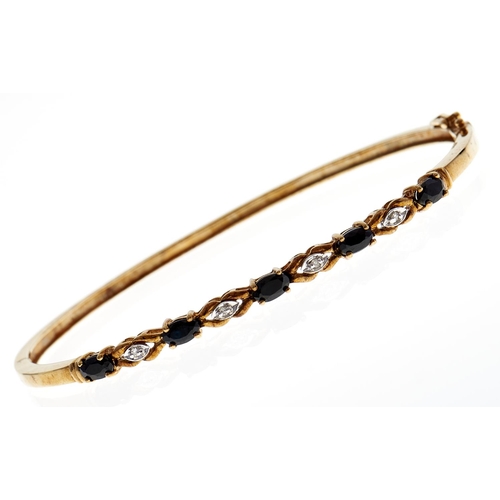 128 - A sapphire and diamond bangle, in two colour 9ct gold, 7.4g