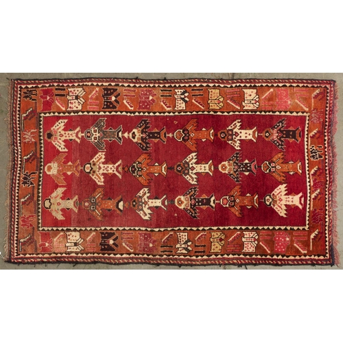 1441 - A modern Caucasian multi-coloured bordered rug, the shaded red ground worked with three rows of six ... 