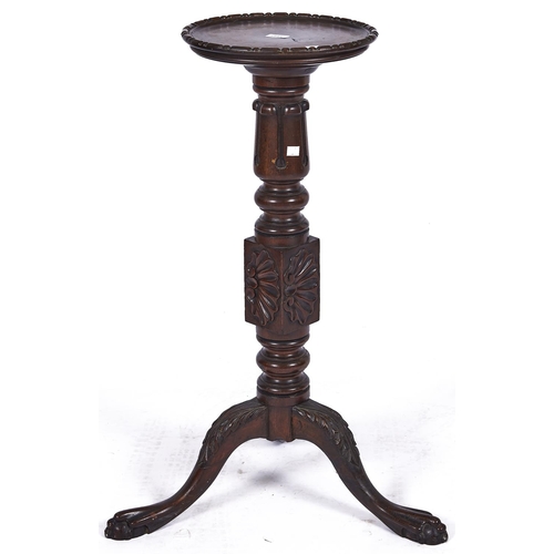 1493 - A mahogany tripod torchere, the dished circular top with bead carved rim, fluted turned column above... 