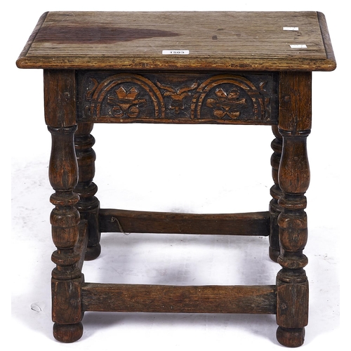 1503 - An old reproduction oak joined stool, the rectangular top with moulded lip above arcade carved friez... 
