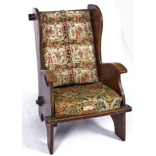 1507 - A barrel back winged chair with pegged top rail, second quarter 20th c , the panelled and boarded co... 
