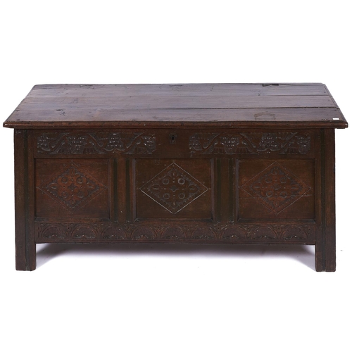 1552 - An oak blanket chest, late 17th c, the rectangular plank top above a frieze carved with stylised gra... 
