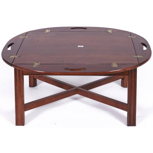 1557 - A reproduction mahogany butler’s tray on stand, the tray of conventional form with kidney shap... 
