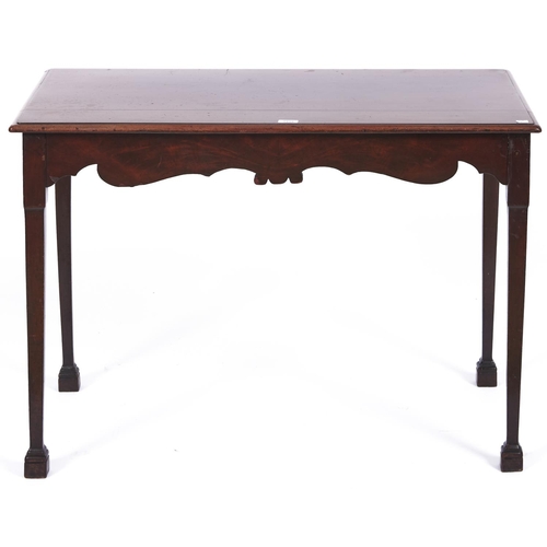 1558 - A mahogany side table, the rectangular top with moulded lip above a figured shaped frieze on square ... 