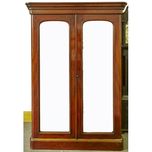 1559 - A Victorian mahogany double wardrobe, c1870, with flared moulded cornice and shallow frieze, pair of... 