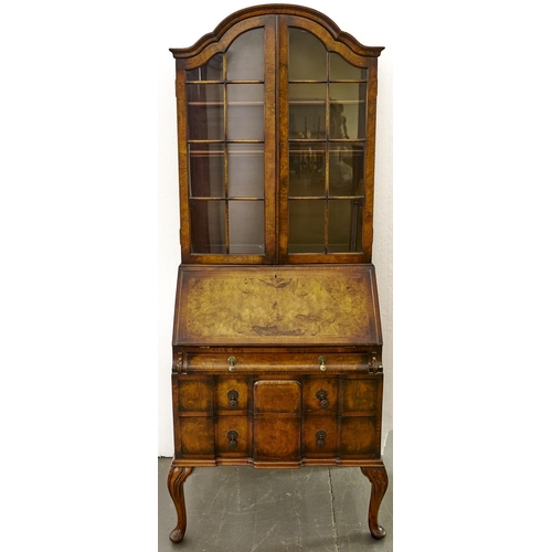 1560 - A  burr walnut  bureau bookcase in Queen Anne style,   c1930, the arched top enclosed by a pair of g... 