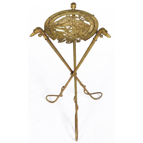 1566 - An unusual gilt lacquered iron stand, c1890, the horseshoe shaped openwork top with the head of a br... 