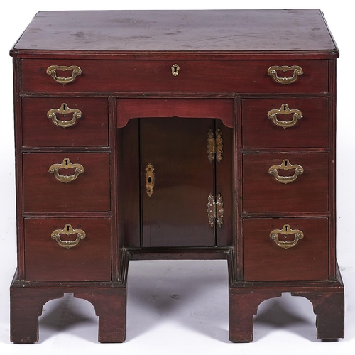 1588 - A George III mahogany kneehole desk or dressing table, late 18th c, with moulded top and fitted seve... 