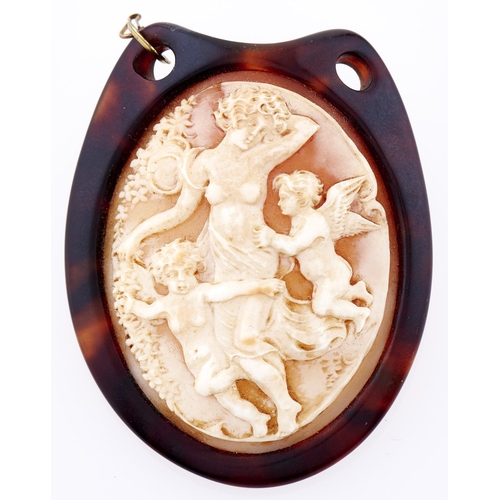 289 - A cameo, the oval shell carved with Venus and putti, set in a tortoiseshell brooch