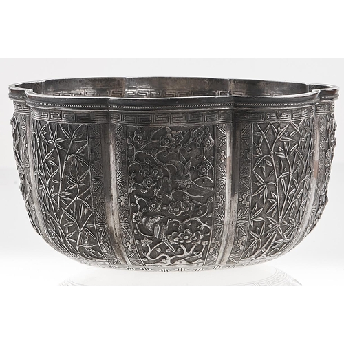 358 - A Chinese silver repousse sugar bowl, c1900, the lobed sides crisply chased with panels of warriors ... 