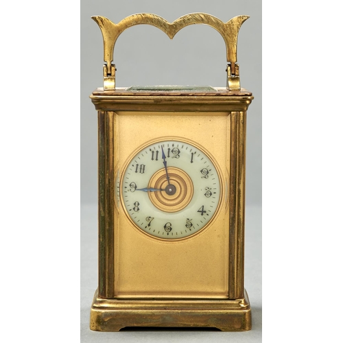 987 - A French brass carriage timepiece, with primrose enamel chapter ring and giltmetal mask, key, 11cm h... 