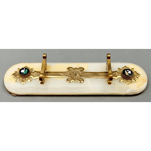 993 - A Victorian gilt brass mounted onyx pen rest, c1880, set with two inlaid Ashford black marble floral... 