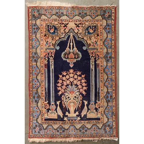 1452 - A Caucasian multi coloured bordered prayer rug, the mihrab with flower filed urn, birds and lamp and... 
