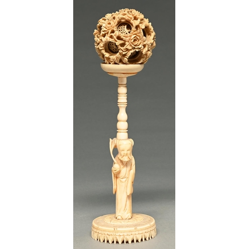 1113 - A Chinese carved ivory puzzle ball, the stand in the form of Shou Lao, 19th c, 23cm h... 