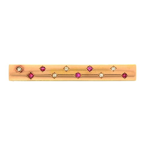 115 - An art deco ruby and diamond bar brooch in the form of a gold baton, c1930, 60mm l, unmarked, 7g... 