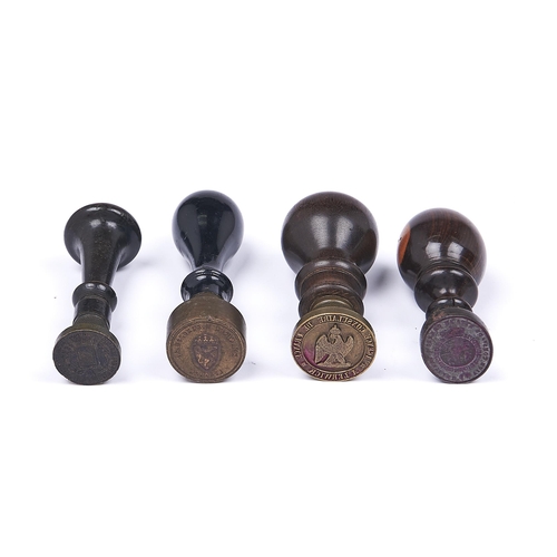 1100 - Four hand seals with brass, bronze or steel matrix and turned lignum vitae, laburnum or ebonised han... 