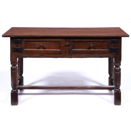 1322 - A 17th c style oak hutch, late 19th c, the over-sailing rectangular top above a pair of panelled rec... 