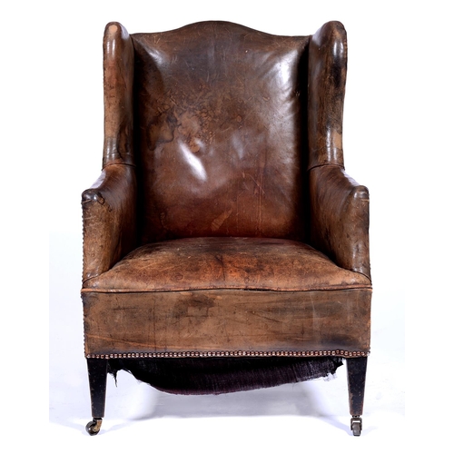 1325 - An Edwardian wingback armchair, c1905, the serpentine back, wings and stuffed over seat upholstered ... 