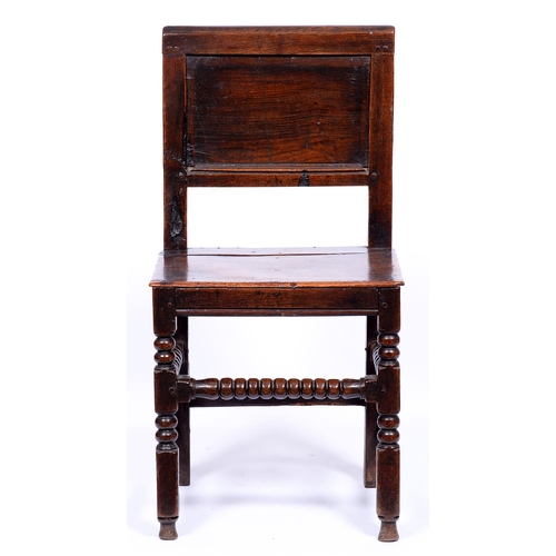 1346 - A mid 17th c oak chair, rectangular panelled back, boarded seat above bobbin and block turned legs w... 