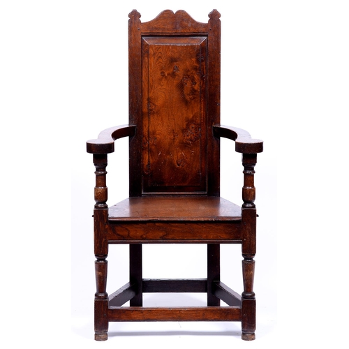 1347 - An oak panel back armchair, early 20th c,  in 17th c English style, the back with raised and fi... 