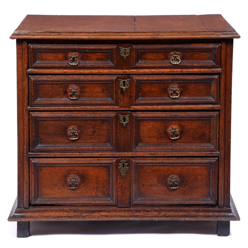 1348 - A William III geometric moulded oak chest of drawers,  with horizontally boarded top, the sides pane... 