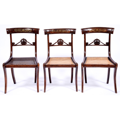 1350 - A set of three Regency brass inlaid and grained rosewood dining chairs,  with carved anthemion ... 